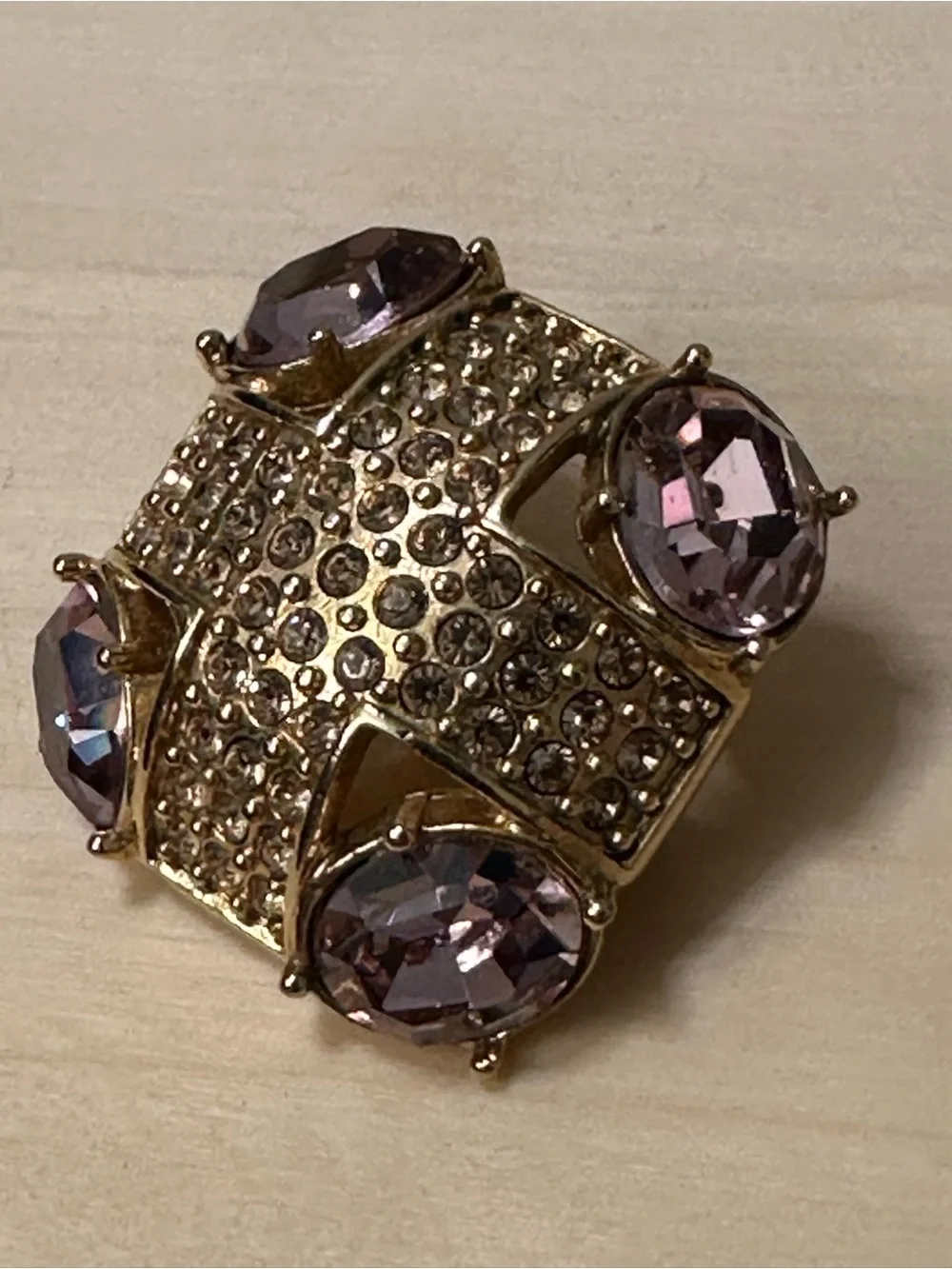 Monet gold-tone brooch with an abstract geometric design with purple stones
